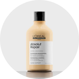 L’Oréal Absolut Repair professional shampoo bottle in peach/beige color.