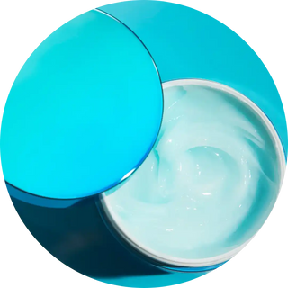 Creamy white moisturizer or face cream in a turquoise container.