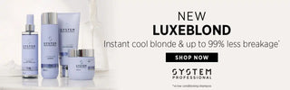 Hair care product bottles in purple and silver tones from the Luxeblond System Professional line.