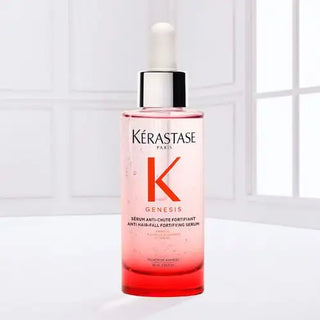 Kerastase genesis anti-hair fall fortifying serum in a clear glass bottle with white dropper cap.