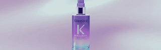 Lavender spray bottle with white label and clear cap, kerastase hair product.