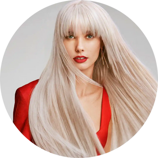 Portrait featuring platinum blonde hair, red lipstick, and a red top.