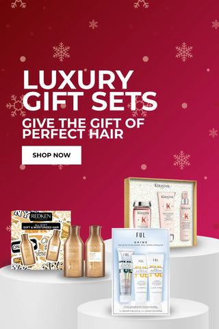 Redken luxury gift set with gold accents and white snowflake design.