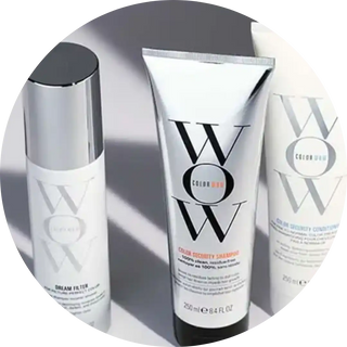 Three white and silver Color Wow hair care products arranged together.