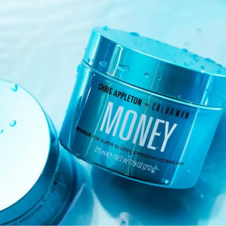 Turquoise-colored cosmetic cream jar labeled ’MONEY’ by Chris Appleton + Color Wow.