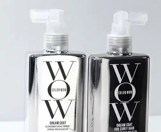 Two black and white ’WOW’ branded spray bottles with pump dispensers.